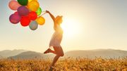 Frau auf Feld mit Luftballons - Foto: canva.com