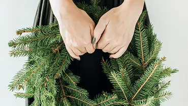 Frau hält Adventskranz - Foto: Canva.com Frau hält Adventskranz - Foto: Canva.com